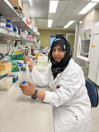 Female scientist in laboratory holding pipette